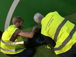 Health and Safety - Screen installation while wearing high visibility jacket