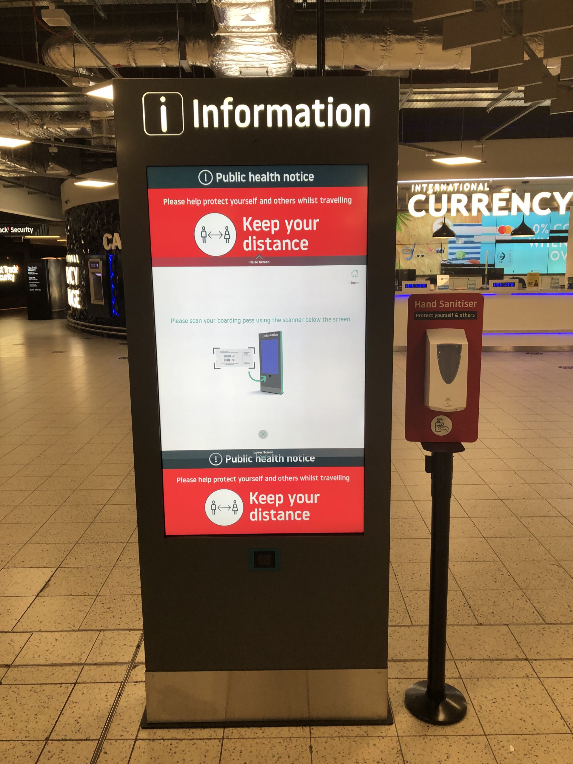 London Luton Airport Wayfinding Information Totem with hand sanitizer stand next to it